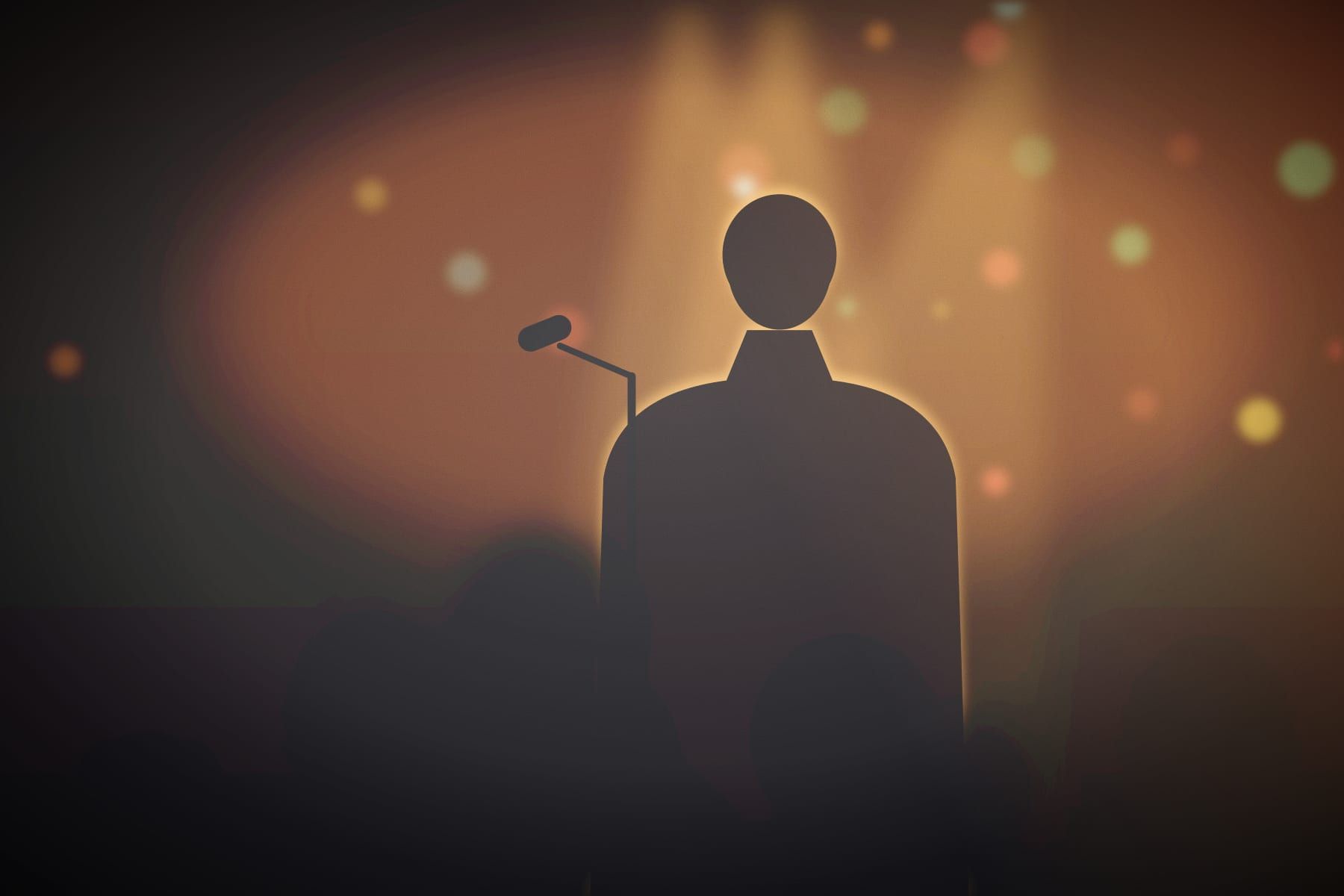 A singer backlit by amber stage light