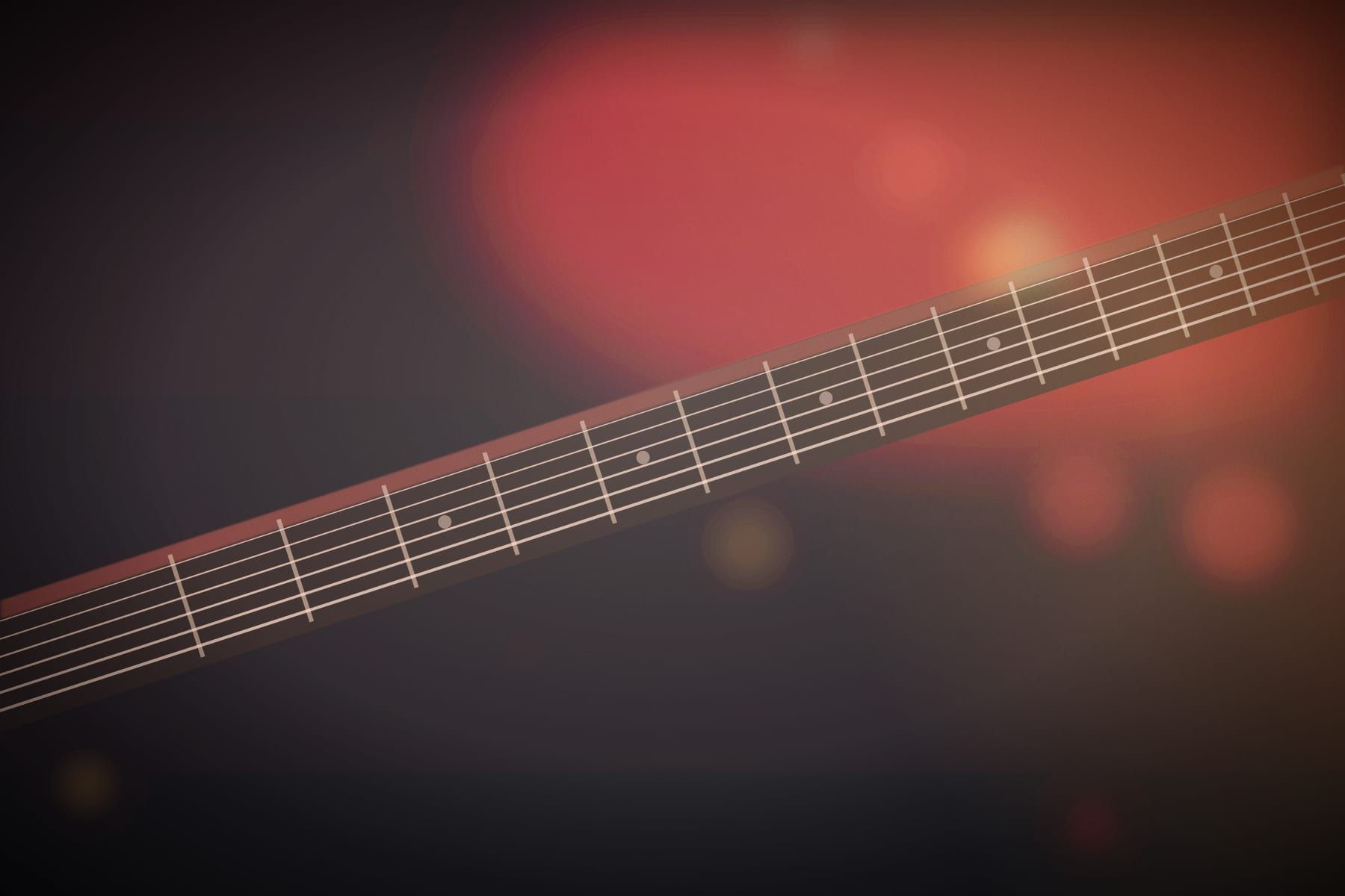 Close-up of a guitar neck in red light